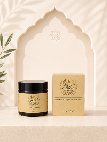 A jar of Shiba Organics Divine Tallow hair and skin oil next to its matching beige packaging box, styled on a beige surface with a decorative arch background.