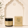 A jar of Shidha Organics 'The Healer' alongside its matching beige packaging box, styled on a marble surface in front of a decorative archway.