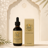 A bottle of Shika Organics Nourishing Roots herbal oil next to its matching beige box packaging, styled on a stone surface with a decorative arch background and soft leaf shadows.